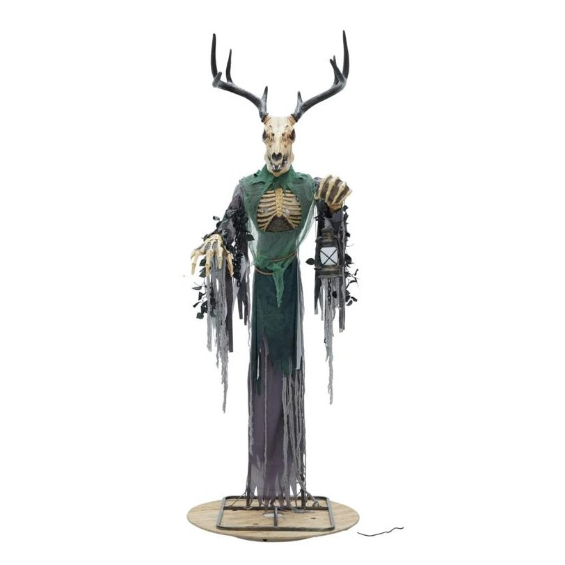 A Halloween decorative figure of a skeletal deer with large antlers, a green tattered robe, exposed rib cage, and a small lantern in one hand, standing on a round base against a white background.