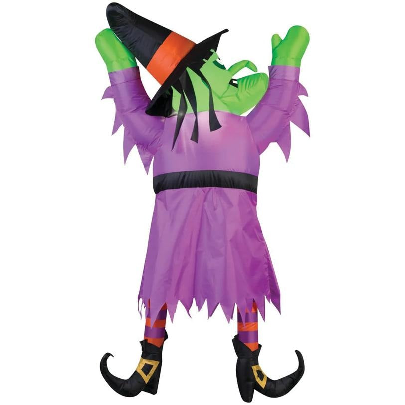 Inflatable witch decoration with purple dress, green gloves, and black shoes on a white background