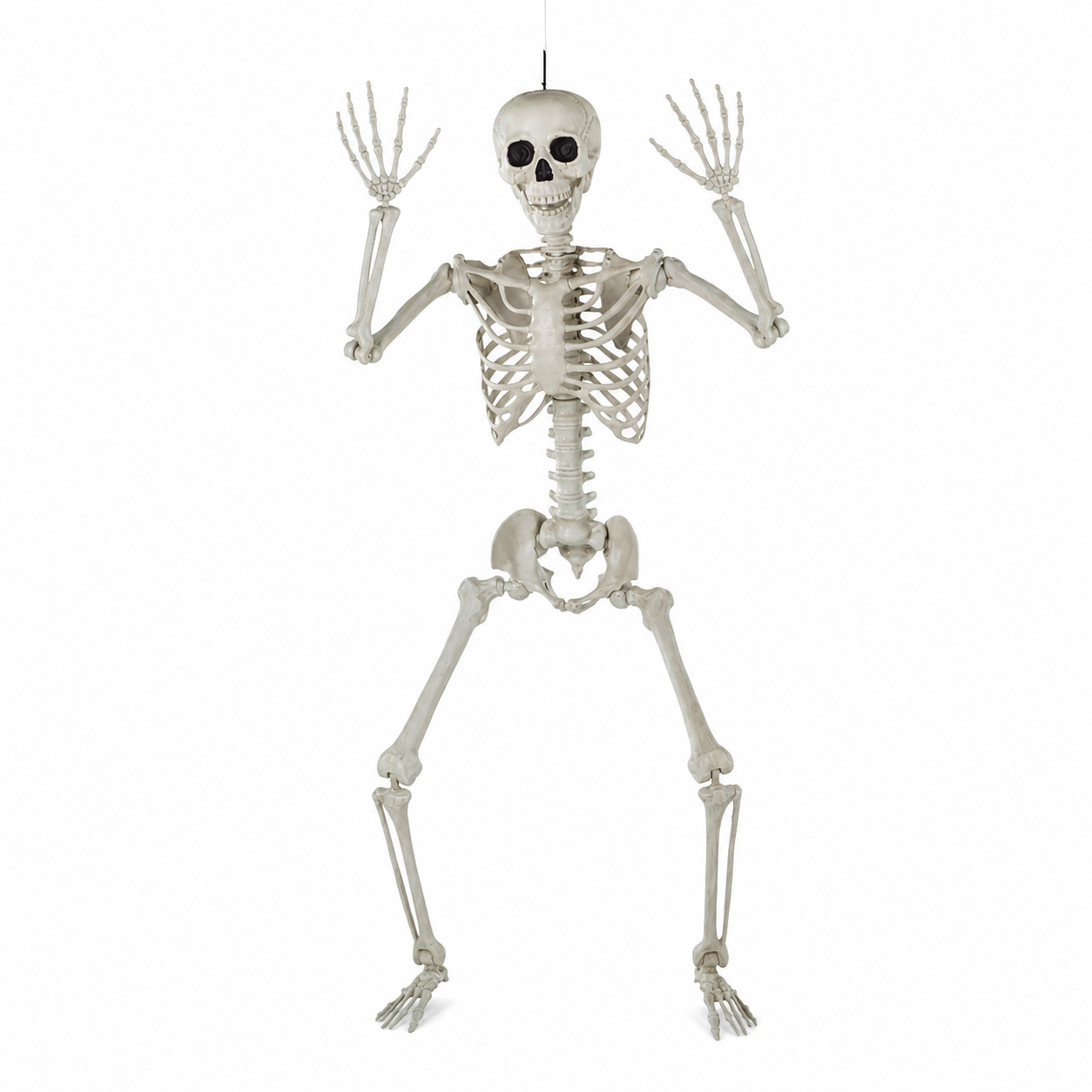 A full-body plastic skeleton decoration posed with arms raised, hanging against a plain white background.