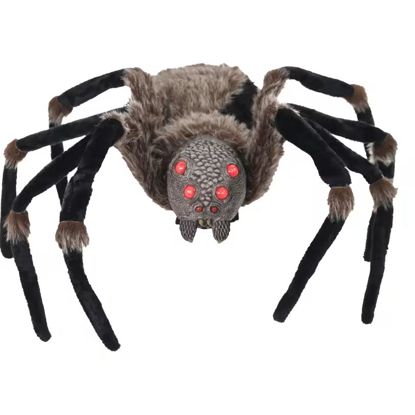 Large spider toy with red eyes on a white background