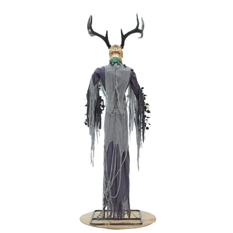 A Halloween decorative figure of a ghostly man with antlers, wearing a tattered gray and purple robe with a green neck scarf, standing on a round base against a white background.