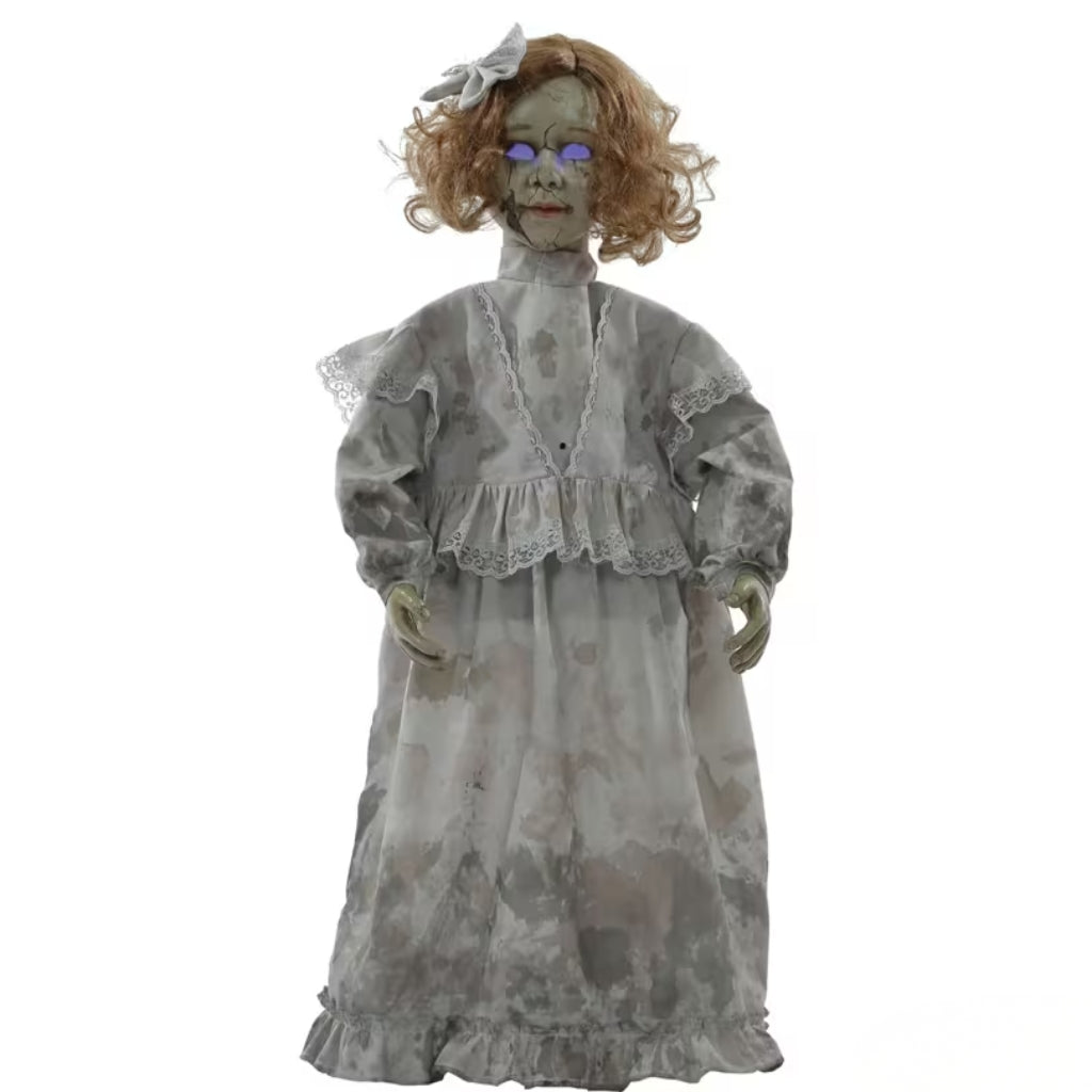 A creepy zombie-style decorative doll with curly light brown hair, a gray tattered nightgown, and glowing purple eyes, isolated on a white background.