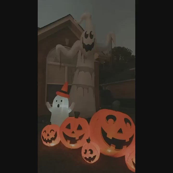 Video of inflatable Halloween Pumpkins in front of 2 inflatable ghosts sitting on a house front lawn